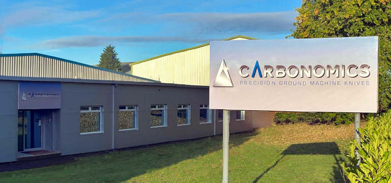Manufacturing headquarters building based in Sheffield, showing the Carbonomics - Precision Ground Machine Knives signage situated on the grass outside of the front offices.